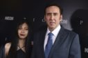 Riko Shibata, left, and Nicolas Cage arrive at the Los Angeles premiere of Pig.