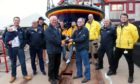 Ron Churchill (right) receives his 40-year long service medal from Arbroath lifeboat operations manager Alex Smith. Pic: Wallace Ferrier.