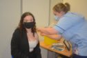 Lily Nicholson is vaccinated by Samantha Wood