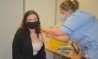 Lily Nicholson is vaccinated by Samantha Wood