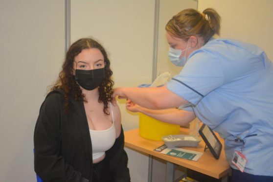 Lily Nicholson is vaccinated by Samantha Wood