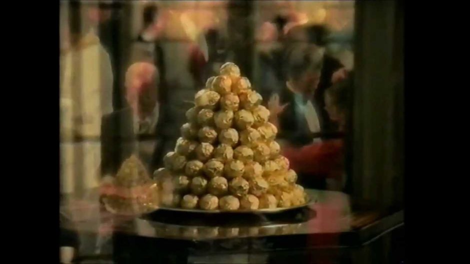 a pile of Ferrero Rocher chocolates on a silver platter.