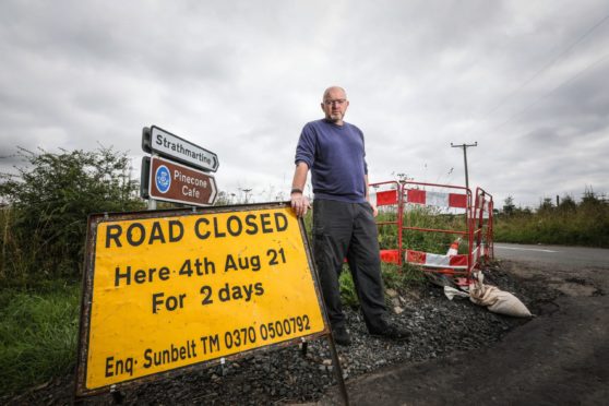 Brian Hughes with the road closure sign