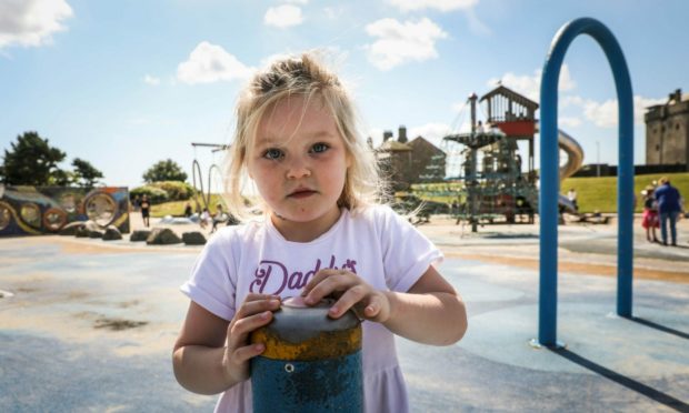 Jamie Corrigan, 3, trying to push the button on the Castle Green Splash Park to make the water go on.