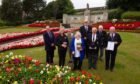 Carnoustie Legion chairman Davie Paton and others involved in looking after the award-winning town memorial. Pic: Paul Reid.