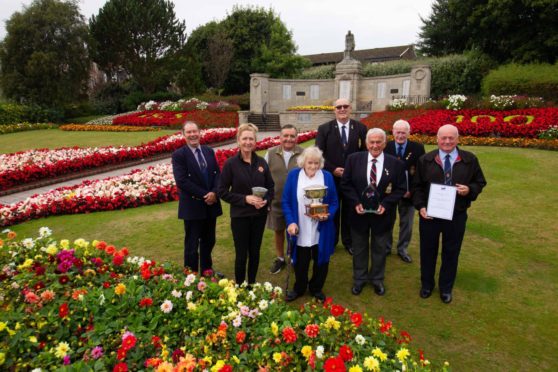 Carnoustie Legion chairman Davie Paton and others involved in looking after the award-winning town memorial. Pic: Paul Reid.