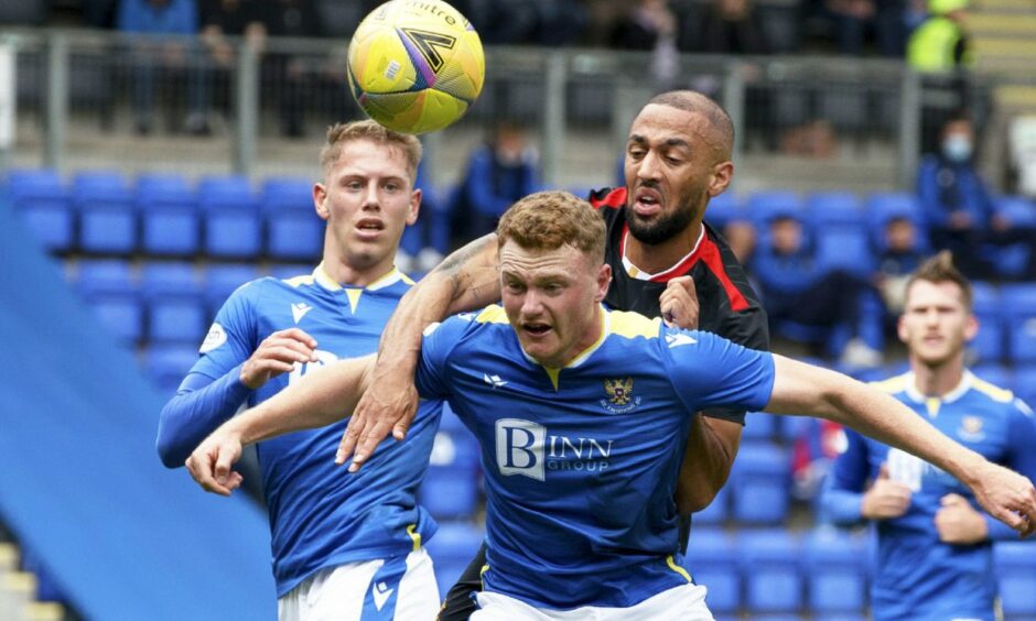 James Brown holds off Rangers' Kemar Roofe in a game for St Johnstone.