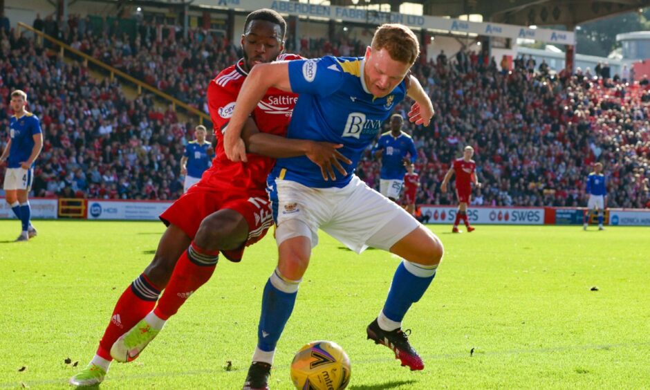 James Brown holds off an Aberdeen opponent as he shields the ball playing for St Johnstone in 2021. 