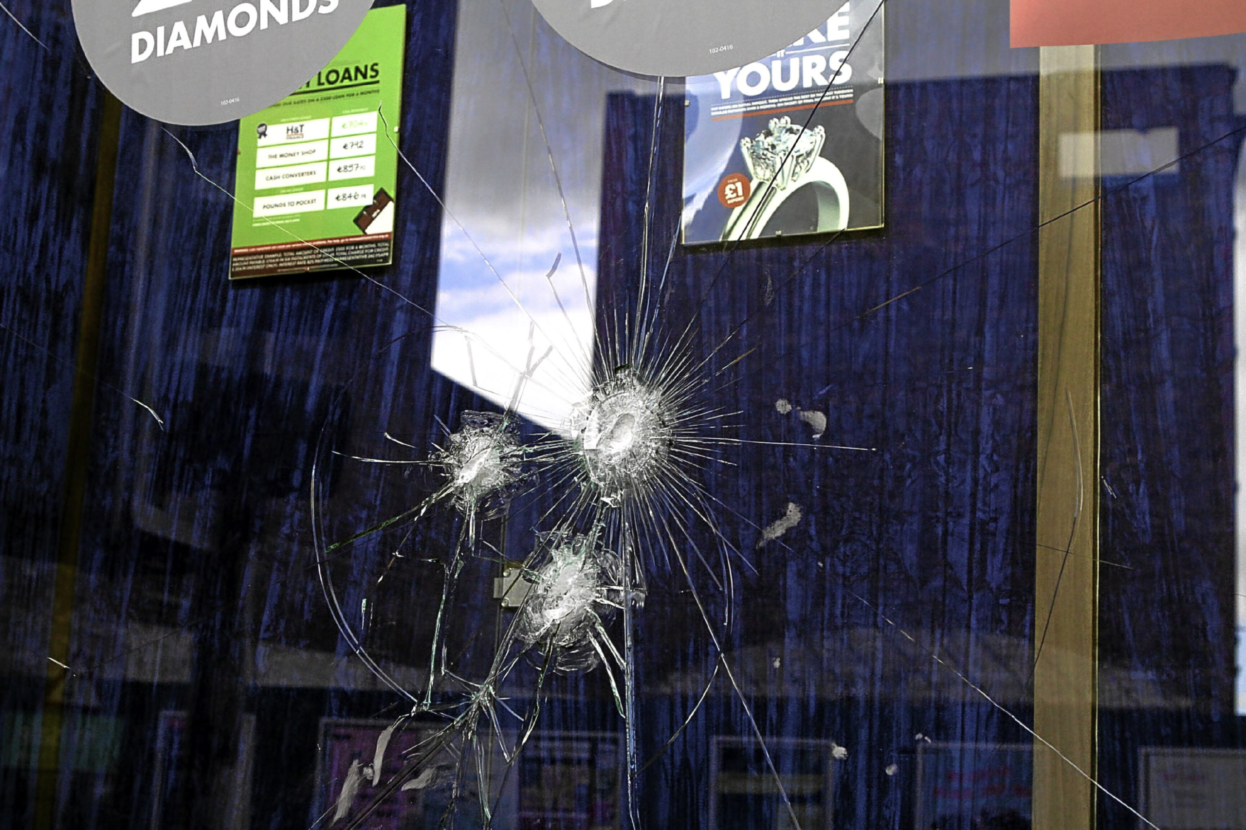 The shop’s damaged window.
