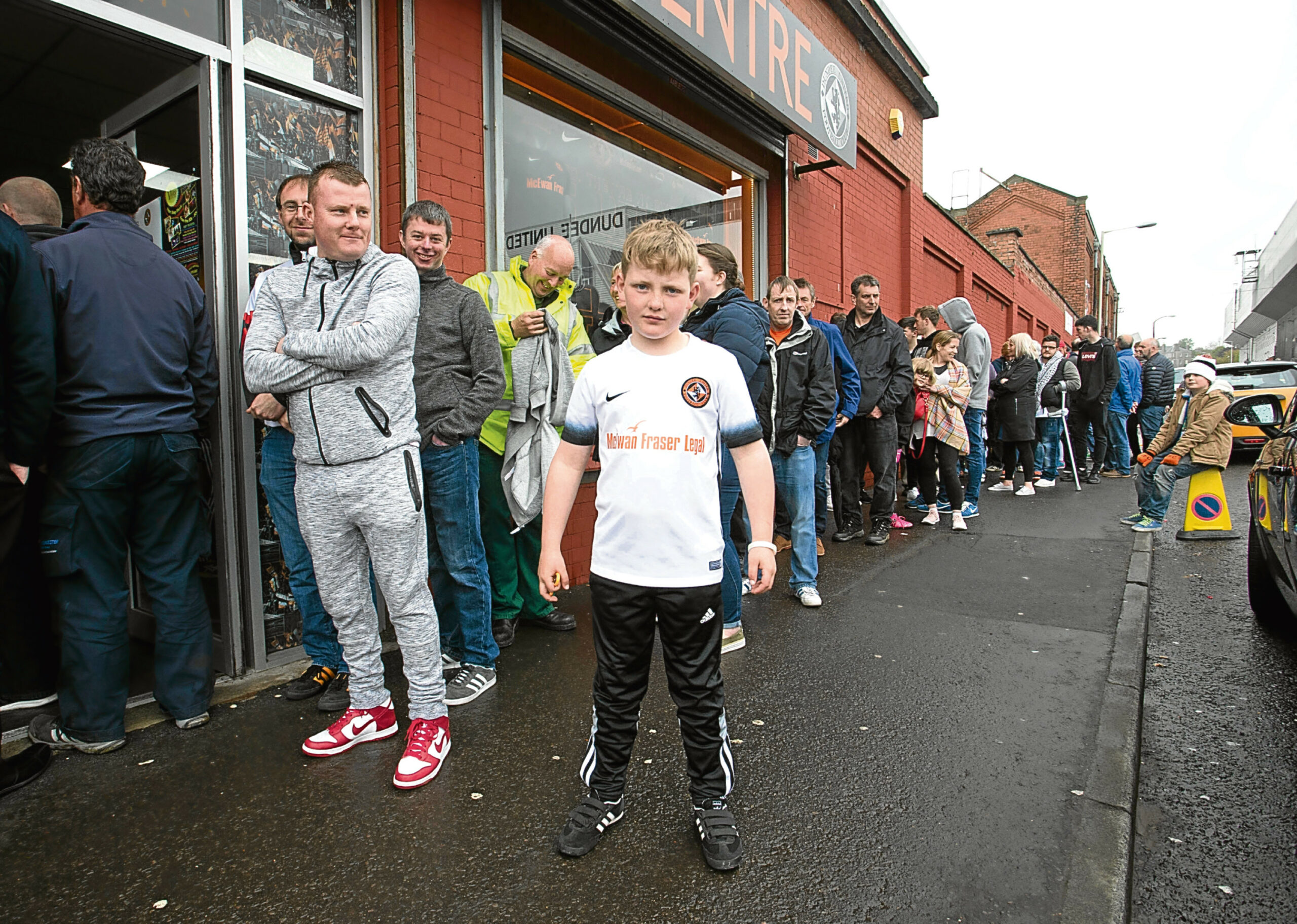 Dundee United fans queue for tickets for the play-off semi-final home leg against Falkirk.