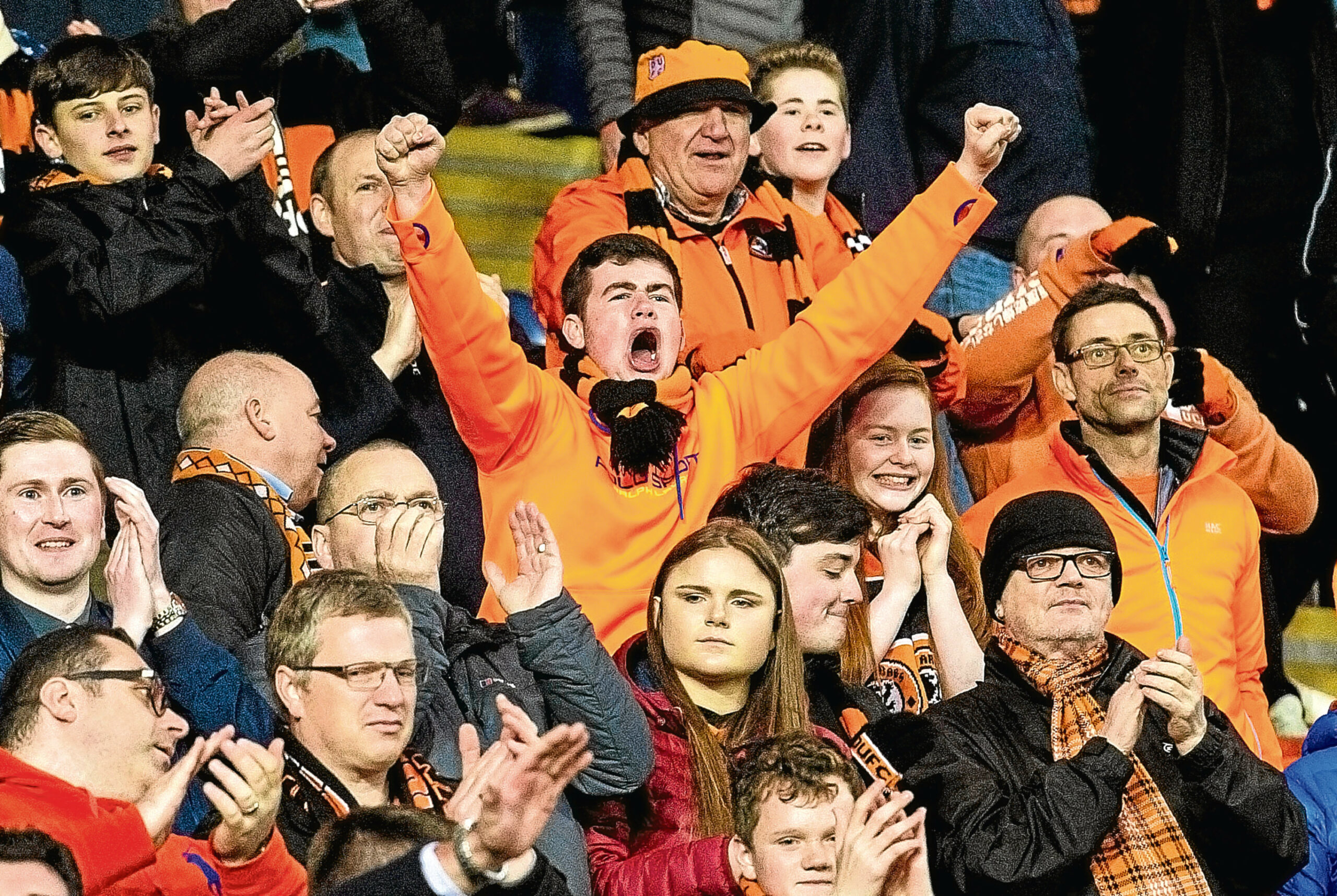 Tangerines fans applaud their team at full-time.