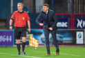 Dundee manager Jim McIntyre watches in frustration as his side are well-beaten by league leaders Hearts at Dens Park on Tuesday night.