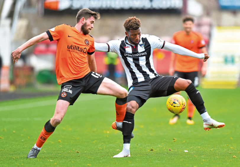 Myles Hippolyte in action for DAFC as Dundee United's Sam Stanton challenges.