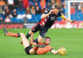 As Sam Stanton shows here, Dundee United needed to display total commitment to win in Dingwall.