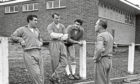 Three England players, Bobby Smith (left) Jimmy Greaves (centre) and Maurice Norman (right) are pictured talking to manager Alf Ramsey before the international match against Scotland.
