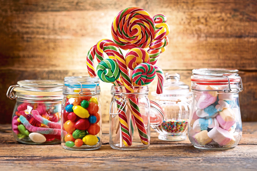 Photo shows old fashioned sweets in jars.