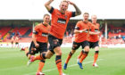 Johnny Russell leads the celebrations during his days at Tannadice.