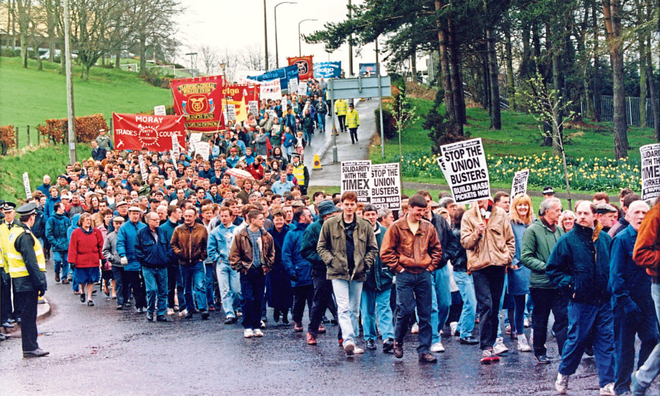 Photo shows hundreds of marchers walking through Dundee in support of striking Timex workers in 1993.