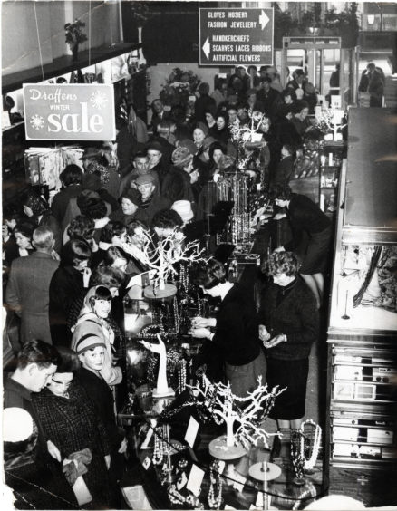 Black and white photo shows a packed sales floor at Draffens of Dundee in the 1960s.