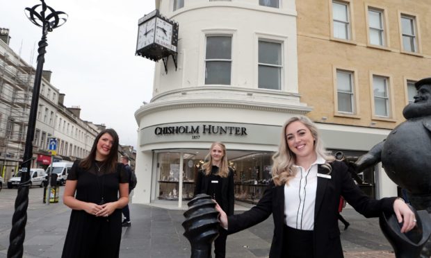 Stef Lindsay, centre, manageress at Chisholm Hunter jewellers in the old H.Samuel shop in Dundee city centre, is keeping and restoring the iconic clock. She's pictured with staff members Alice Heaton, left, and Aimee Cargill.