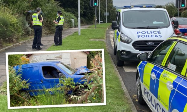 Police are searching for the driver of the van after it crashed into a garden in Dalgety Bay.
