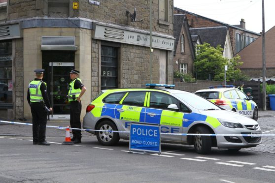 Police at the scene after Allen fell from a window in McGill St.