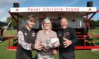 Peter Christie's wife, Heather and son Daniel, 17, at the unveiling of the new stand with Carnoustie Rugby Club president Colin Murray. Pic: Gareth Jennings/DCT Media.