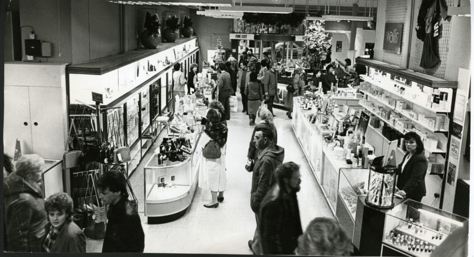 black and white photo shows the bustling interior of the Draffens department store in Dundee in the 1980s.