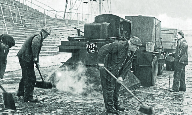 Groundskeepers blasting the pitch at Tannadice Park.