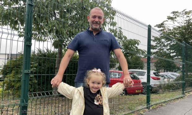Dad Paul McDonald, 48, and daughter Evie McDonald, 3, outside Fintry Primary School.