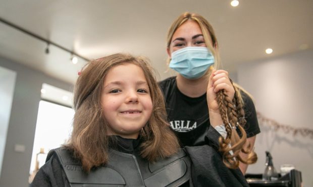 Kirriemuir six-year-old Alix Stewart and stylist Kirsty Reid with the 16 inches cut for the Little Princess Trust.