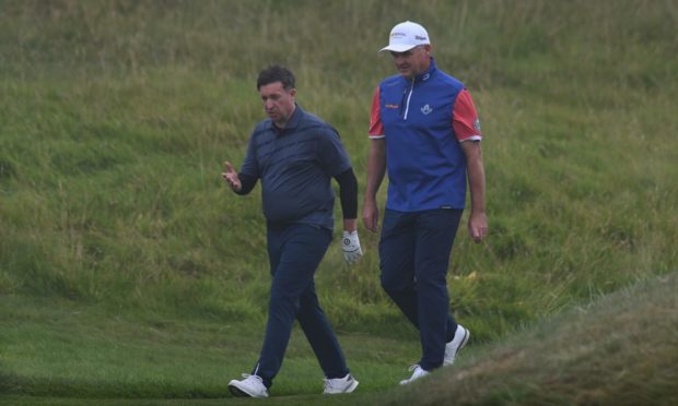 Paul Lawrie chats with Robbie Fowler during the Celebrity Pro-Am