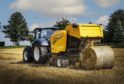 The New Holland Roll-Bar 125 baler in action.