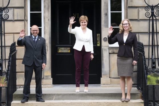 First Minister Nicola Sturgeon (centre) with Scottish Green co-leaders Patrick Harvie and Lorna Slater.