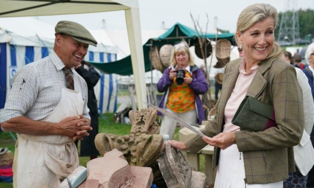 The Countess of Wessex touches some stone work from the home of John Lennon, during the Westmorland County Show in Crooklands, Cumbria. Picture by PA.