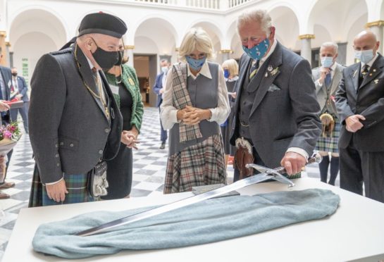 The Duke and Duchess of Rothesay are presented with a replica of the sword of Robert the Bruce during a visit to the redeveloped Aberdeen Art Gallery. Picture by PA.