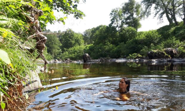 Gayle enjoys a refreshing dip in a pool near the Rocks of Solitude.