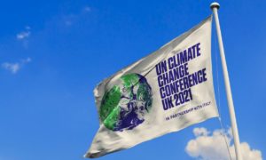 A flag with a picture of earth on it alongside text relating to COP26 Glasgow