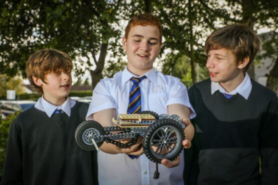 Ethan Mundy, Reuben Watkinson and Brodie Young with their model.