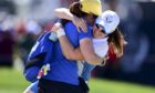 Europe's Leona Maguire celebrates with her twin sister Lisa.