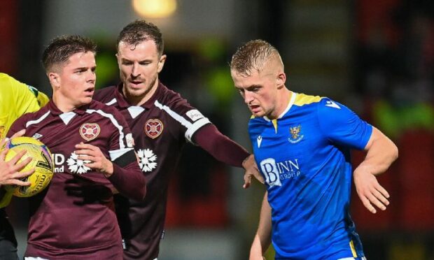 Cammy MacPherson in the thick of the action against Hearts.
