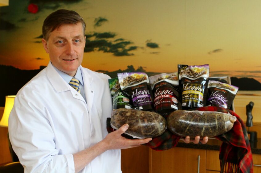 Photo shows Simon Howie holding a selection of haggis products.