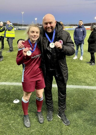 Dryburgh Athletic chairman John Beatt alongside daughter Alix Barclay-Beatt, showing off their medals.