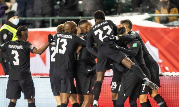 The Canadian players celebrate one of their goals.