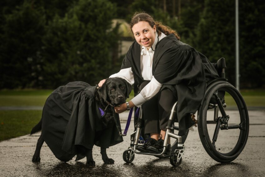 Megan McEvoy, 26, with her service dog Flint.