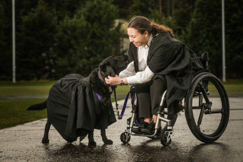 St Andrews graduate Megan McEvoy with her service dog Flint