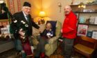 Reg Kydd with piper Peter Bell and James Martin who delivered the Queen's card. Pic: Paul Reid.