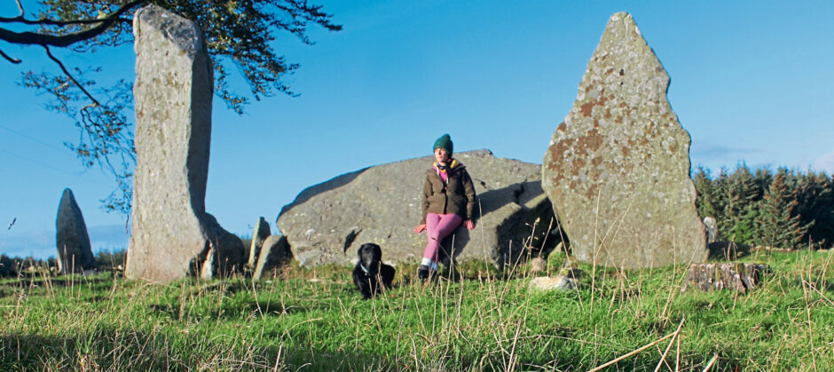 Gayle and her dog Toby exploring Tyrebagger stone circle.