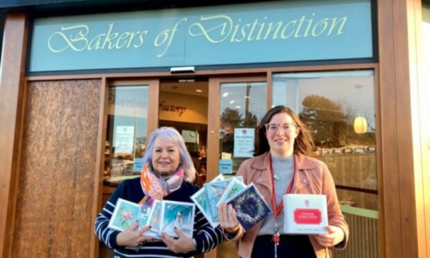 TCCL representative Gaye Steel is pictured with Chloe Milne of Fisher & Donaldson. Cupar, with TCCL Christmas cards