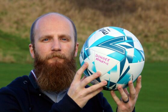 Dundee Athletic manager Matt Smith with a football like the one that landed  up in the Netherlands.
